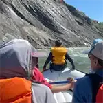 People with life jackets riding on a raft in Wyoming