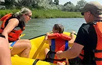 Couple with their daughter in a raft